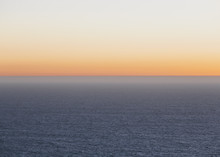 A View Over The Pacific Ocean And The Sunset On The Horizon. 