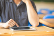 © Tom Wang - young man using a tablet or ipad in a classroom