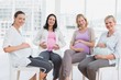 © WavebreakmediaMicro - Smiling pregnant women sitting together at antenatal class