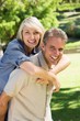 © WavebreakmediaMicro - Man giving piggyback ride to woman