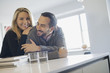 © Mint Images - Couple at home in modern kitchen