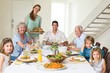 © WavebreakmediaMicro - Family having meal at dining table