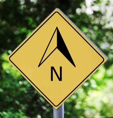 Yellow traffic label with north arrow pictogram