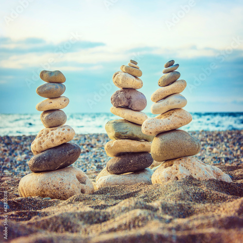 Fototapeta na wymiar Three stacks of round smooth stones