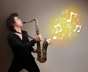 Handsome musician playing on saxophone with musical notes