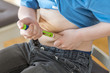 Young boy injecting insulin