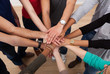 © Andrey Popov - Multiethnic College Students Stacking Hands