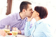 © Kalim - Kissing couple in a restaurant