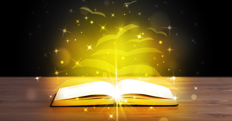 Open book with golden glow flying paper pages