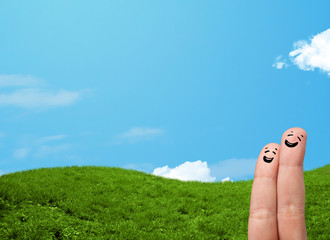 Cheerful finger smileys with landscape scenery at the background