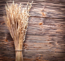 Ears Of Wheat On Old Wooden Table.