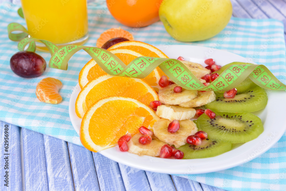 Sweet fresh fruits on plate on table close-up