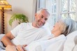 © lightwavemedia - Happy mature couple relaxing in bed