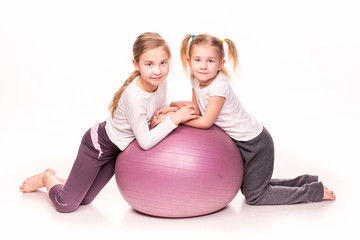 Sticker - Sportive girls on a fit ball isolated over white