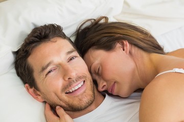 Wall Mural - Close-up of a loving couple lying in bed