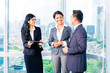 © Kzenon - Asian Businesspeople standing in office