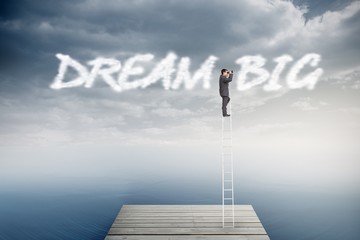 Poster - Dream big against cloudy sky over ocean