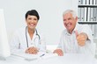 © WavebreakMediaMicro - Happy senior patient gesturing thumbs up with doctor
