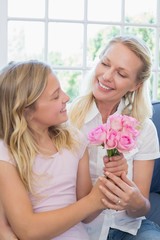 Mother receiving flower bouquet from daughter