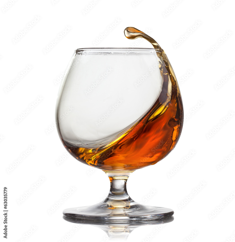 Splash of cognac in glass isolated on white background - obrazy, fototapety, plakaty 
