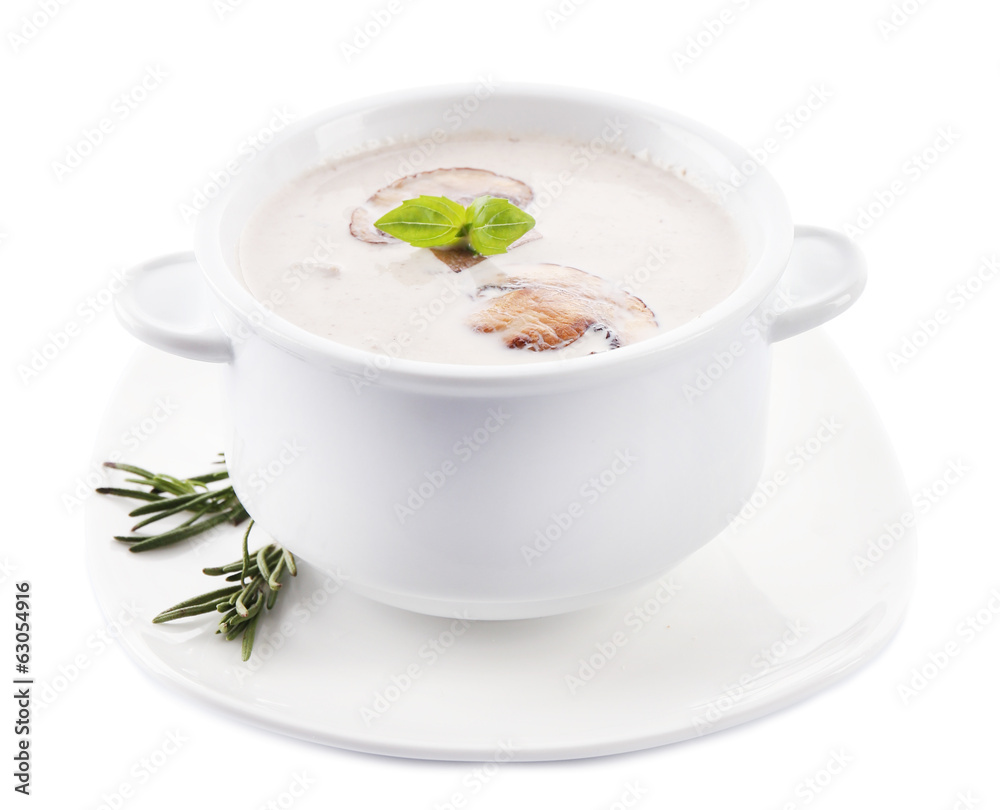 Mushroom soup in white bowl, on plate, isolated on white