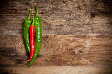 Red hot chili peppers on old wooden table