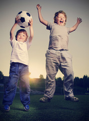 Wall Mural - two happy boy play in soccer