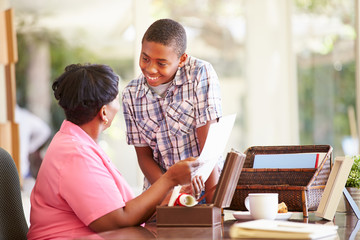 Canvas Print - Grandmother Showing Document To Grandson