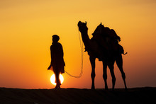 A Desert Local Walks A Camel Through Thar Desert