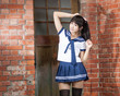 © imagesbykenny - Asian schoolgirl standing in front of school