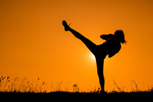 Silhouette Of Kick Boxing Girl Exercising Kick.