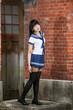 © imagesbykenny - Asian schoolgirl standing in front of school