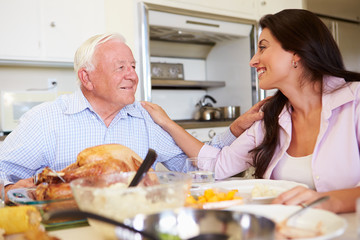 Wall Mural - Father And Adult Daughter Having Family Meal At Table