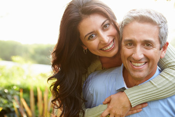 Portrait Of Loving Hispanic Couple In Countryside