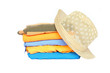 © jianghaistudio - Pile of colorful clothes with a hat over white background