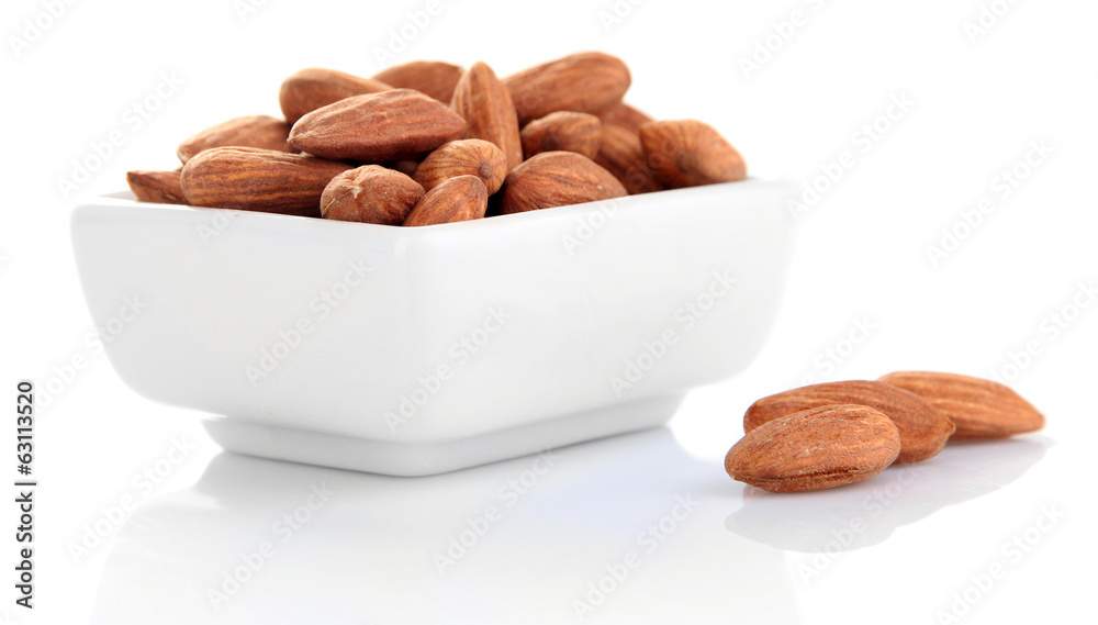 Almond in bowl, isolated on white