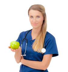 Wall Mural - Smiling nurse or young female doctor giving an green apple.