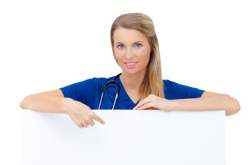 Wall Mural - Nurse / doctor showing blank board / sign.