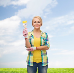 smiling woman with paintbrush