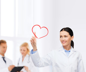 Poster - smiling female doctor pointing to heart