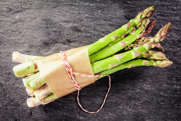 Wall Mural - Fresh asparagus spears tied with brown paper