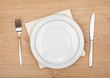 © evgeeenius - Empty plate and silverware set