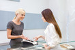© Karramba Production - Salesperson helps lady to choose jewelry at jeweler's shop