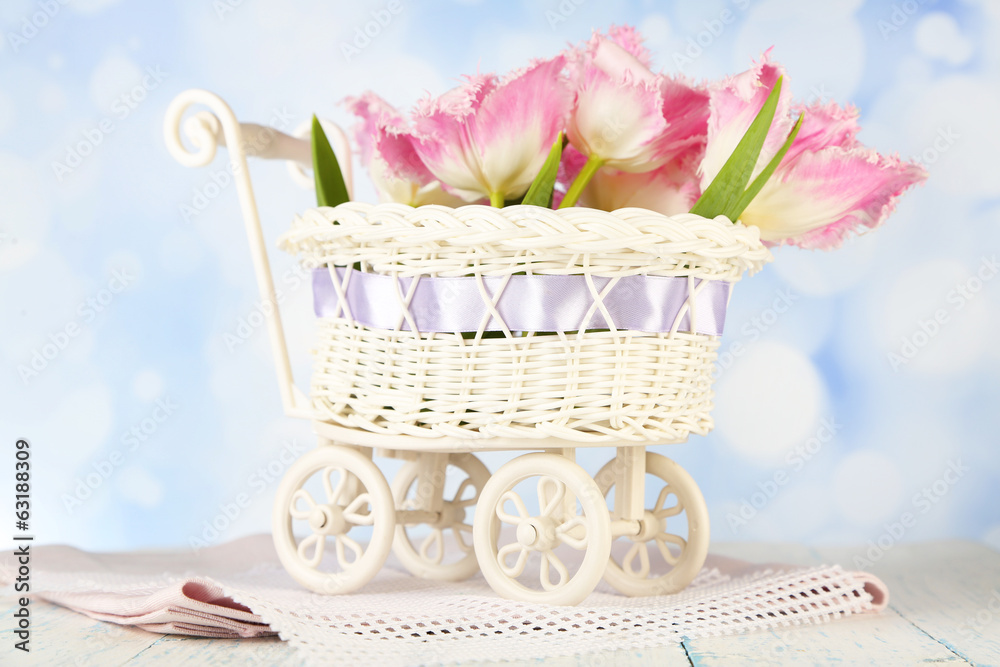 Beautiful tulips in decorative wicker basket,