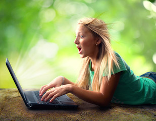 Surprised Teenage Girl with Laptop Outdoors