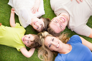 Poster - Familie liegt auf der Wiese