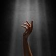 © adam121 - woman's hand reaches for the light rays