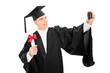 © Ljupco Smokovski - College graduate taking a selfie with phone