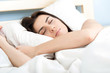 © vladteodor - Attractive young woman sleeping in bed