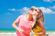 © el.rudakova - Closeup of happy young couple in sunglasses on beach smiling and